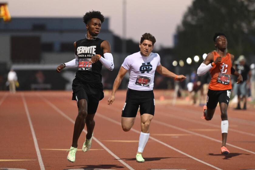 ARCADIA, CA - APRIL 9, 2022: Max Thomas, left, of Servite, wins the boys' 200 meter dash at the Arcadia track and field invitational. (Michael Owen Baker / For The Times)