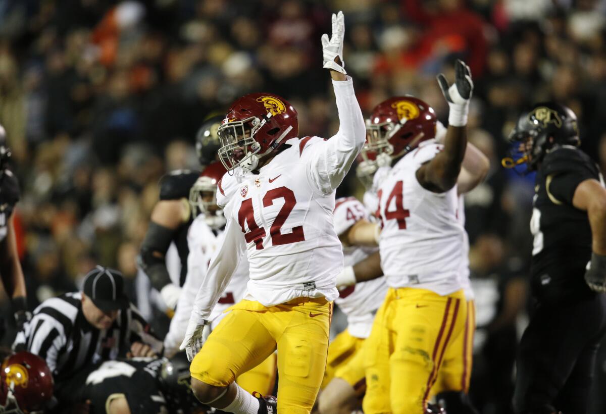 USC linebacker Uchenna Nwosu (42) signals after the Trojans recover a fumble by Colorado running back Christian Powell during a game on Nov. 13.