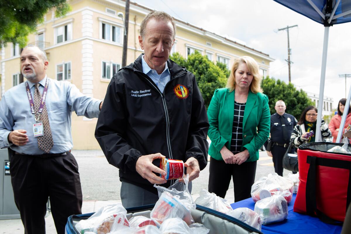 LAUSD Supt. Austin Beutner gives a tour of a food distribution location at John Liechty Middle School in downtown Los Angeles on March 17.