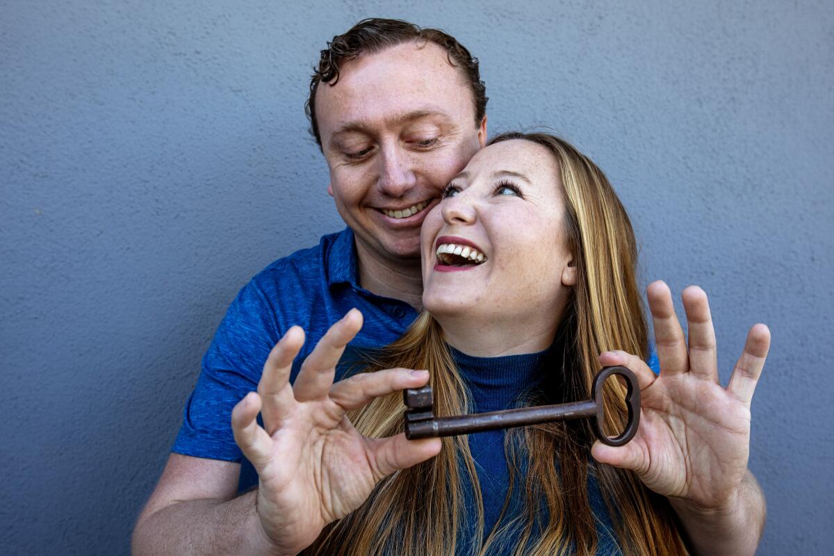 Couple holding a large old-fashioned key