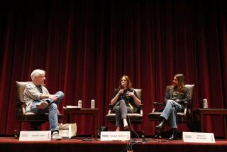 A male moderator and two female writers seated onstage at USC.  