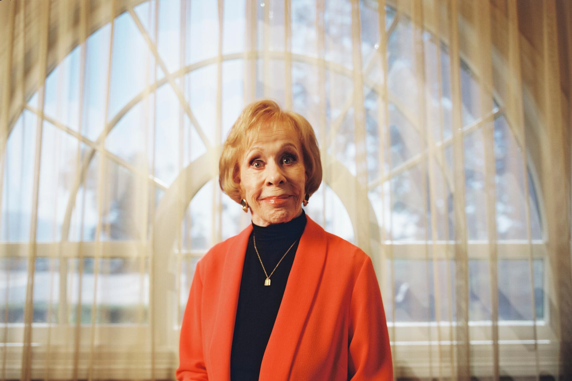 Carol Burnett wears a bright jacket over a black top for a portrait.