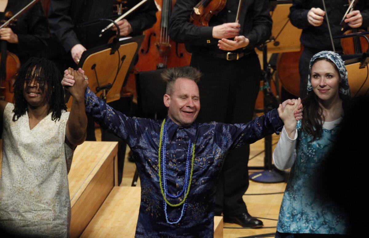Peter Sellars, center, shown in 2013 with Anani Dodji Sanouvi, left, and Tamara Mumford, after Sellars' staging of John Adams' "The Gospel According to the Other Mary" with the L.A. Philharmonic.