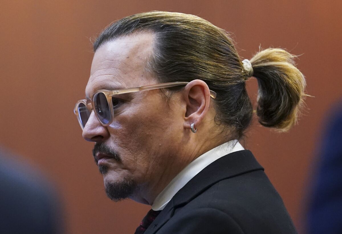 Actor Johnny Depp appears in the courtroom at the Fairfax County Circuit Courthouse in Fairfax, Va., Wednesday, May 18, 2022. Actor Johnny Depp sued his ex-wife Amber Heard for libel in Fairfax County Circuit Court after she wrote an op-ed piece in The Washington Post in 2018 referring to herself as a "public figure representing domestic abuse." (Kevin Lamarque/Pool Photo via AP)