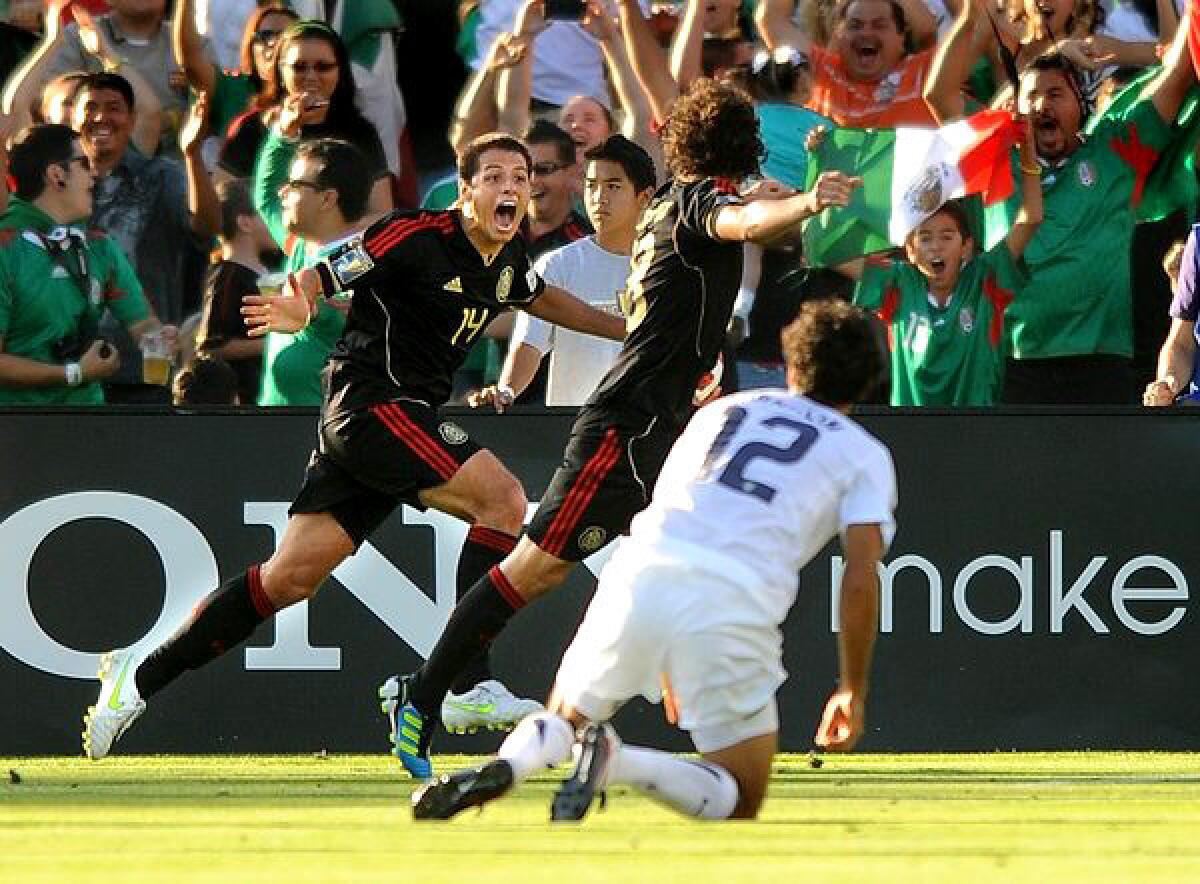 Mexico's Javier Hernandez, left, celebrates with Andres Guardado after he scored against Jonathan Bornstein (12) and the U.S. in the 2011 Gold Cup championship match at the Rose Bowl.