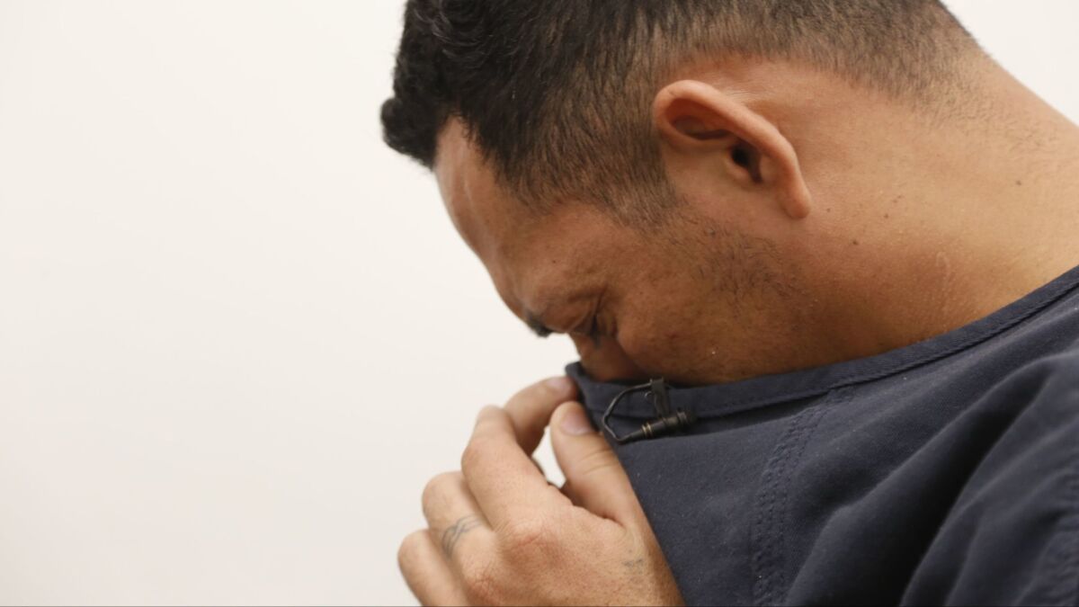 At Otay Mesa Detention Center, Eric Matute Castro, 33, wipes his tears as he speaks of his son taken from him by immigration officials after he asked for asylum.