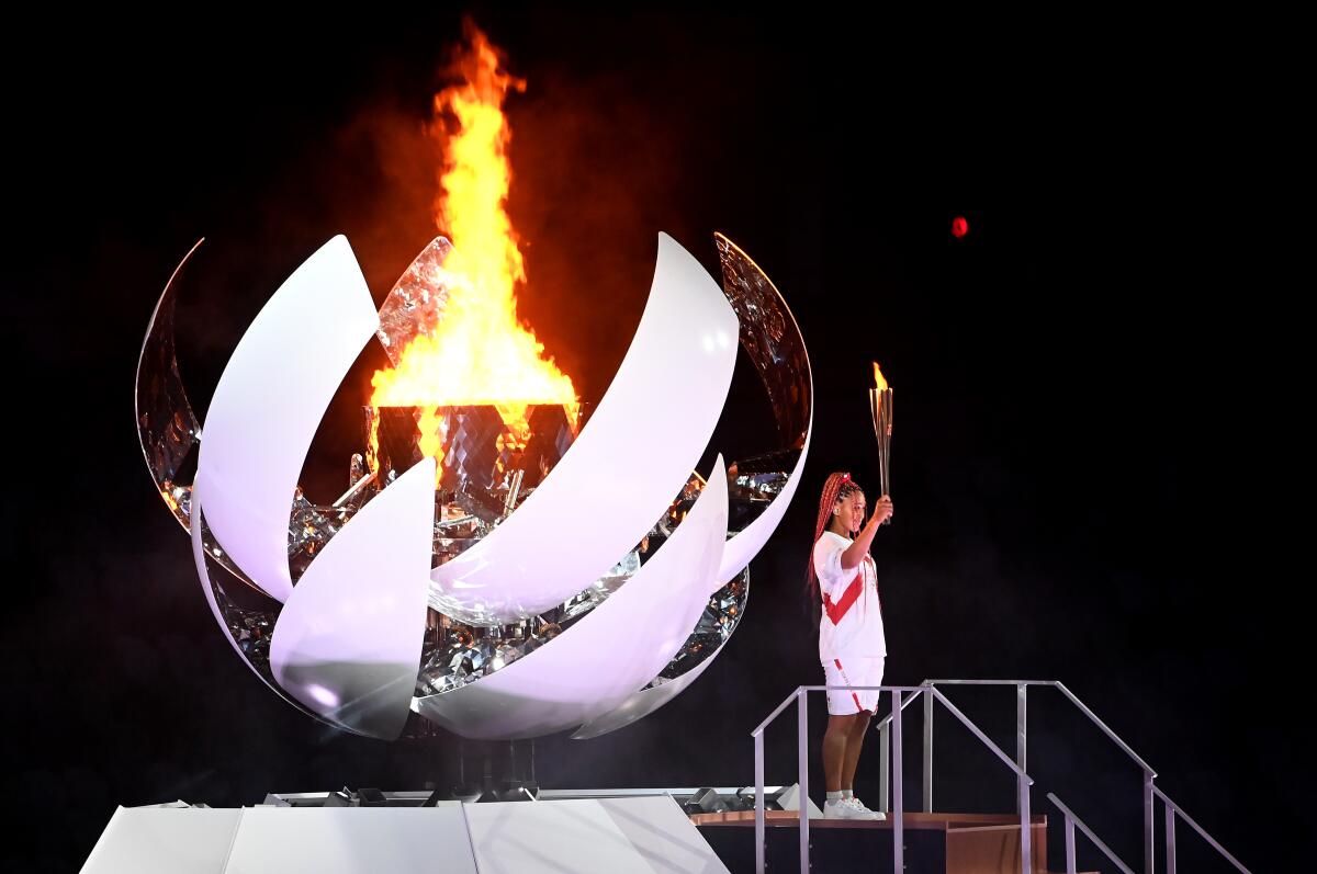 Naomi Osaka lights the Olympic torch during opening ceremony of the Tokyo Games.