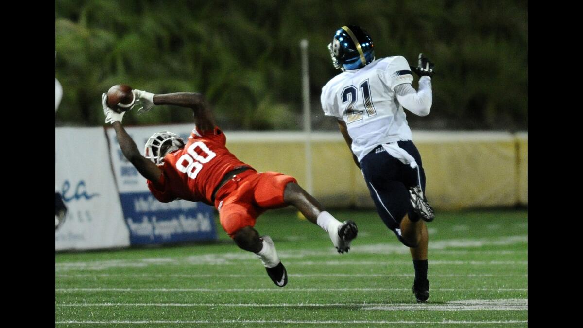 Mater Dei receiver Andre Collins makes a catch against St. John Bosco's Mykal Tolliver in the third quarter Friday.