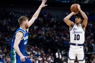 Los Angeles Lakers guard Max Christie (10) attempts a three point shot as Dallas Mavericks forward Davis Bertans (44) defends him in the first half of an NBA basketball game in Dallas, Sunday, Dec. 25, 2022. (AP Photo/Emil T. Lippe)