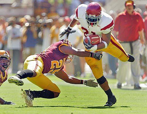 Arizona State's Robert James, left, tries to pull down USC tailback LenDale White during the first quarter at Sun Devil Stadium in Tempe, Ariz.