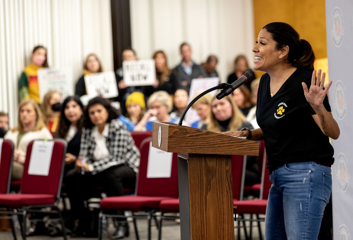 A concerned parent, Jessica Nettles, speaks in front of a crowd 