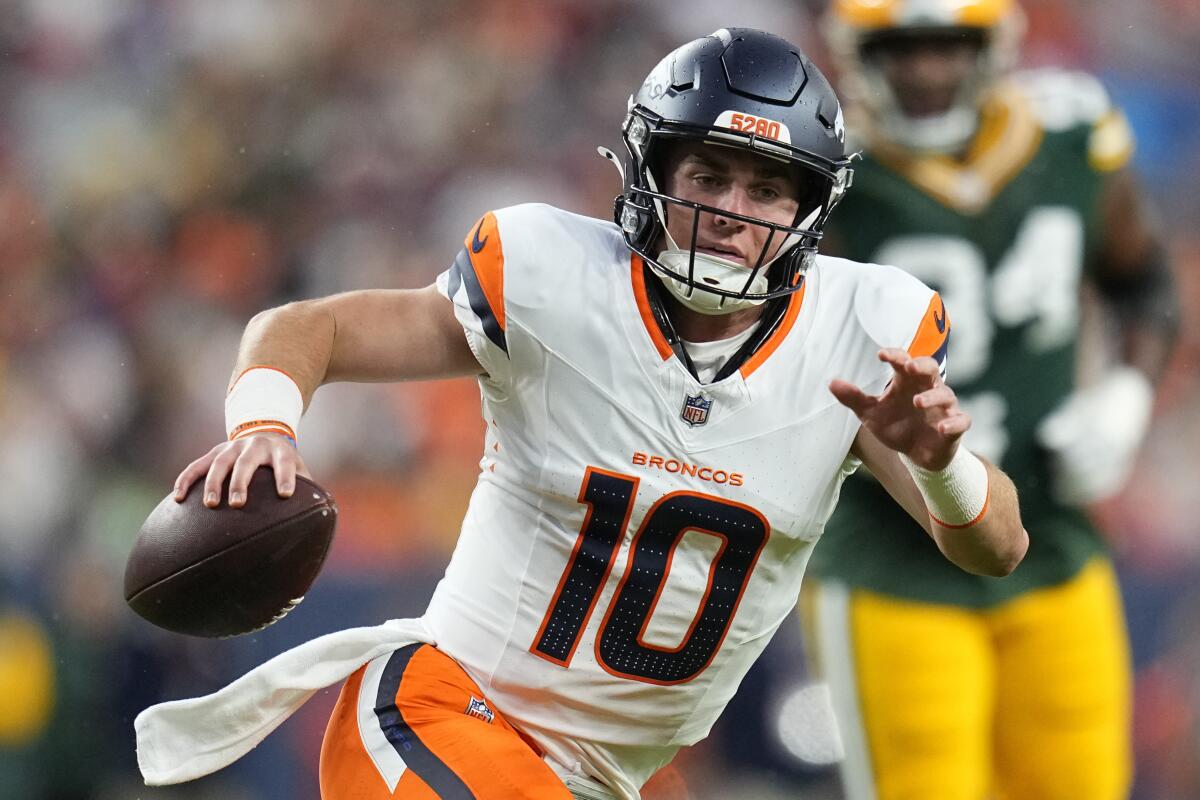 Denver Broncos quarterback Bo Nix scrambles against the Green Bay Packers during a preseason game.