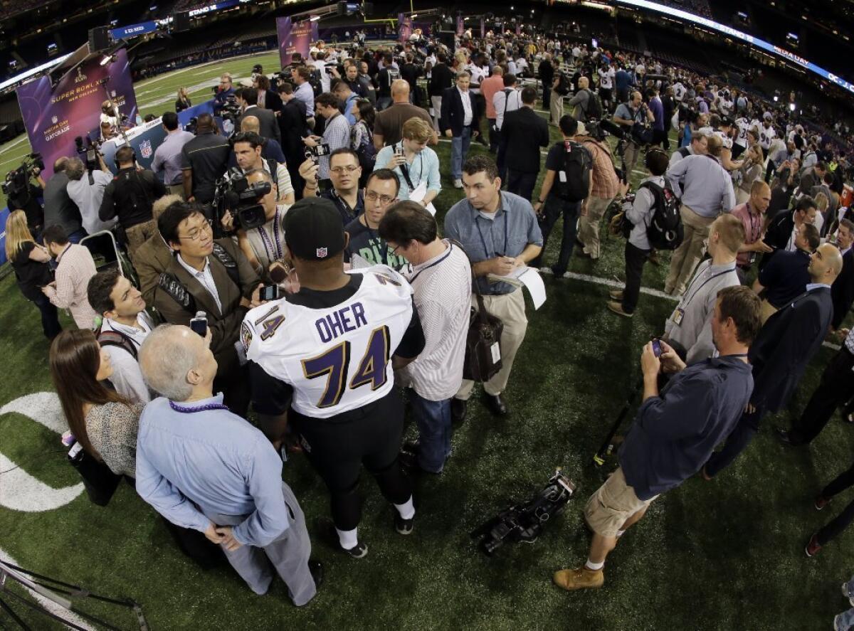 Michael Oher speaks to the assembled media on Tuesday.
