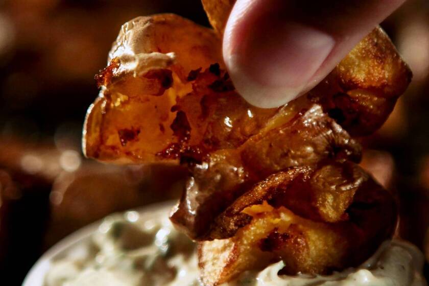 Smashed fried potatoes with creamy ranch dipping sauce.