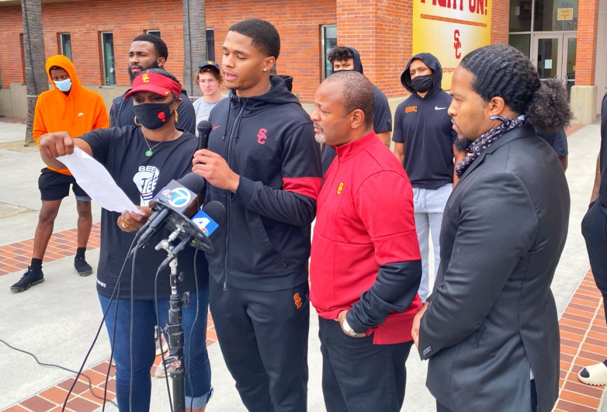 Suspended USC wide receiver Munir McClain, center, speaks during a new conference Sunday at USC. 