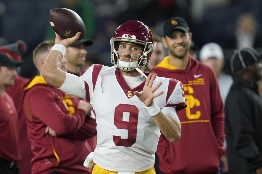 Southern California quarterback Kedon Slovis (9) throws during warmups before an NCAA college football game.