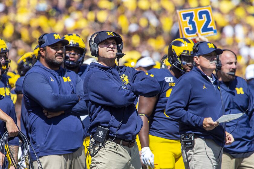 Michigan head coach Jim Harbaugh, center, reacts looking up at the scoreboard in the second quarter of an NCAA football game against Army in Ann Arbor, Mich., Saturday, Sept. 7, 2019. (AP Photo/Tony Ding)