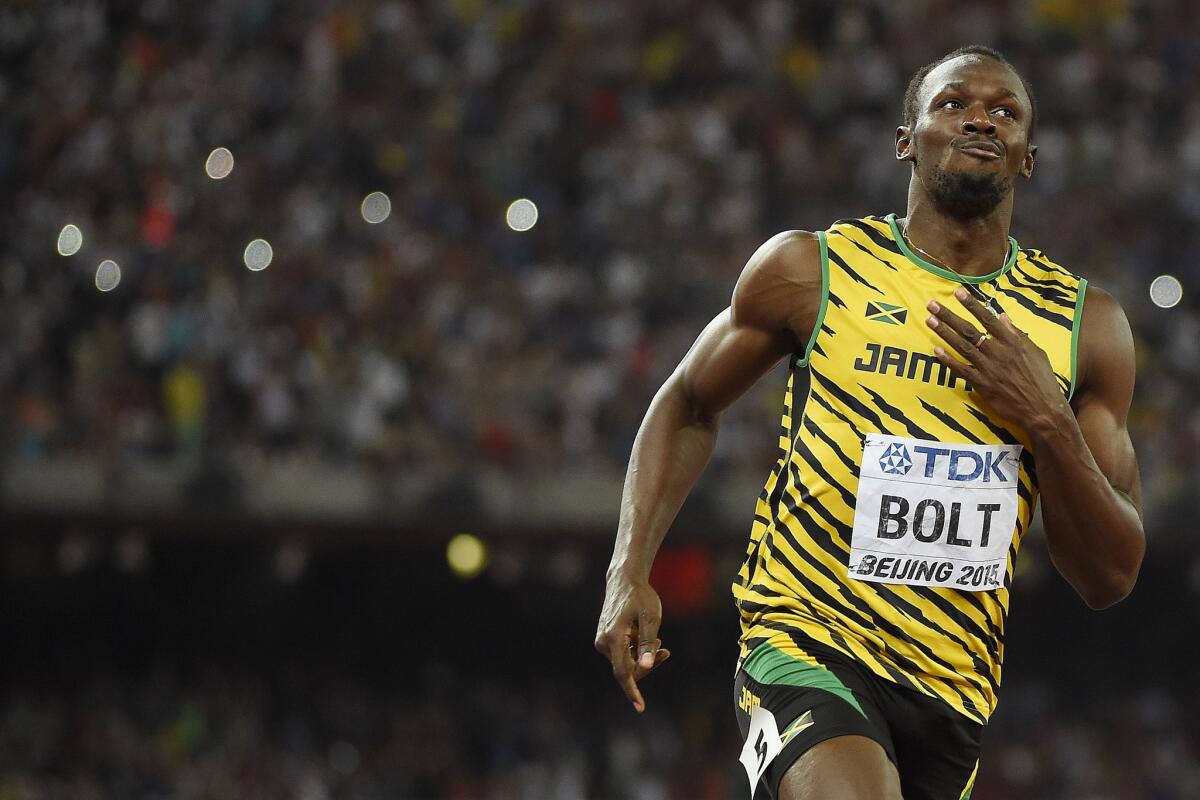 Usain Bolt pulls up after winning the 100-meter dash at the world track championships.