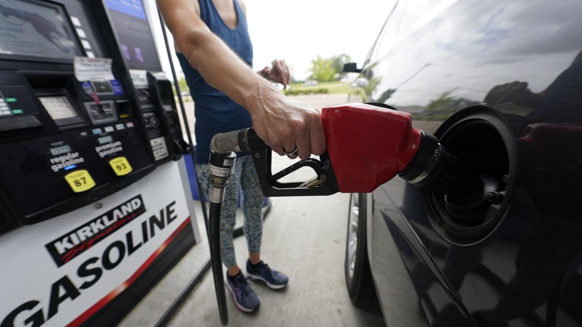 A customer readies to pump gas