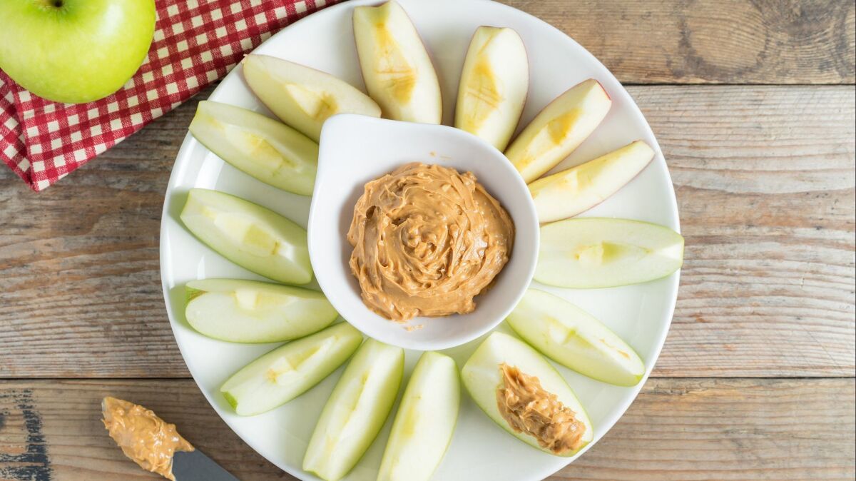 Green apple slices with peanut butter.