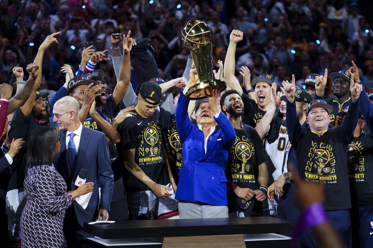 Owner Stan Kroenke holds up the Larry O'Brien Trophy after his Denver Nuggets won the NBA championship.