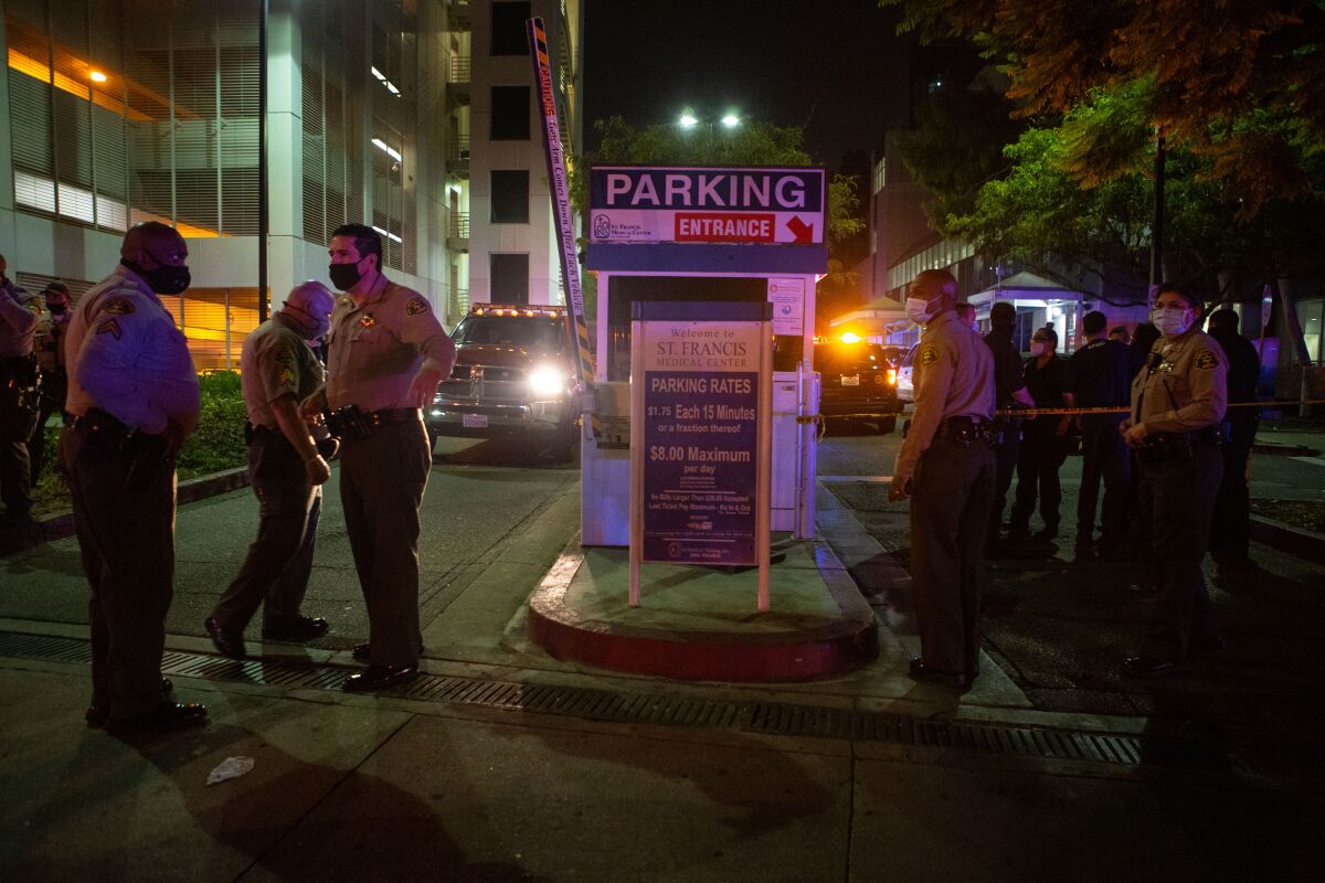 Sheriff's deputies outside St. Francis Medical Center on Saturday after the shooting of two colleagues.