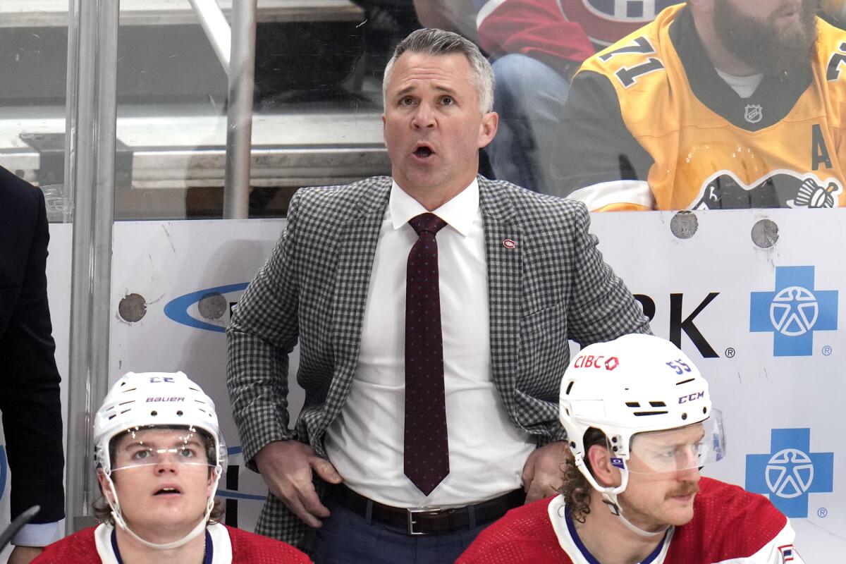 FILE - Montreal Canadiens head coach Martin St-Louis, top, looks at the scoreboard during the first period of an NHL hockey game in Pittsburgh, Jan. 27, 2024. St. Louis is back with the Canadiens after he left the team to be with his family. Montreal announced that he will be behind the bench again the Tuesday, March 26, 2024, game at Colorado. (AP Photo/Gene J. Puskar, File)