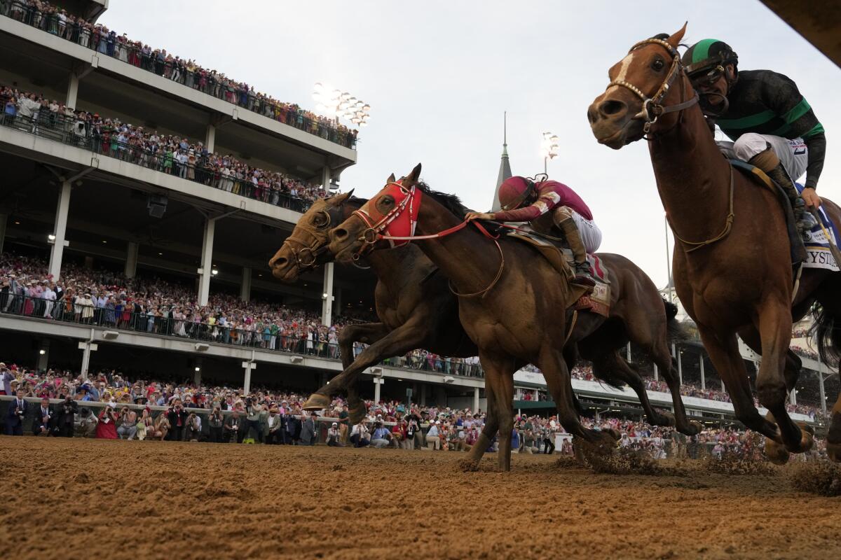 Brian Hernandez Jr. rides Mystik Dan, right, to victory in the 150th running of the Kentucky Derby.
