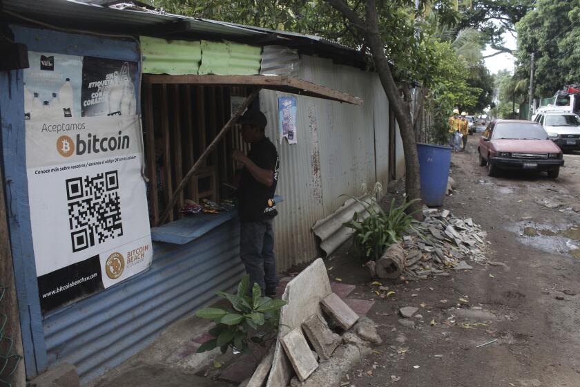 Santos Hilario Galvez, a Salvadoran who works as a builder at the Hope House, an organization that sponsors the use of cryptocurrencies in El Zonte beach, makes a purchase at a small store that accepts Bitcoin, in Tamanique, El Salvador, Wednesday, June 9, 2021. El Salvador's Legislative Assembly has approved legislation making the cryptocurrency Bitcoin legal tender in the country, the first nation to do so, just days after President Nayib Bukele made the proposal at a Bitcoin conference. (AP Photo/Salvador Melendez) (AP Photo/Salvador Melendez)