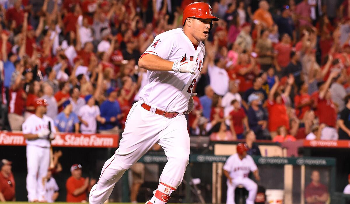Angels' Mike Trout rounds the bases after hitting a three-run homerun in the seventh inning against the Texas Rangers on Monday at Angel Stadium.