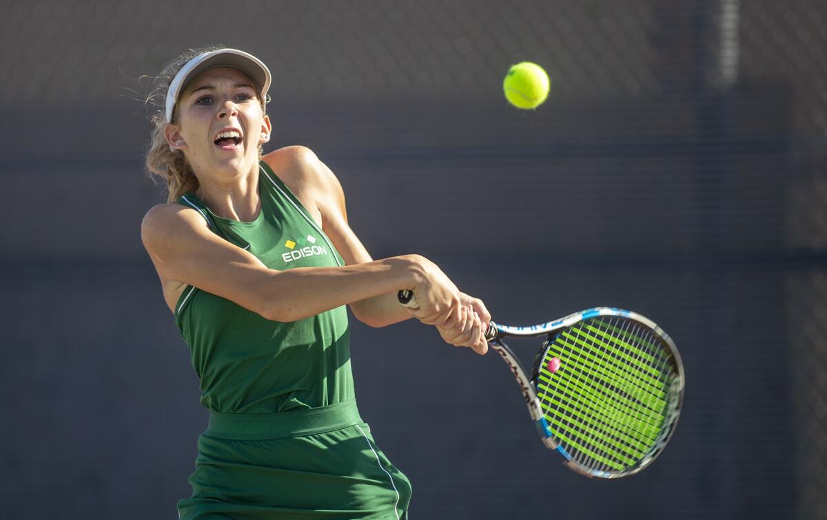 Edison's Zoe Coggins returns a ball against Huntington Beach's Kaytlin Taylor in a Wave League match on Tuesday.