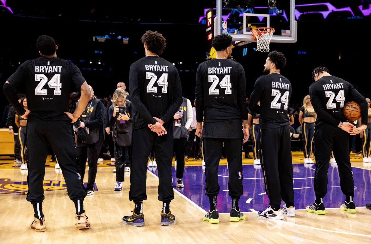 Lakers players wear shirts honoring Kobe Bryant during pregame warmups.