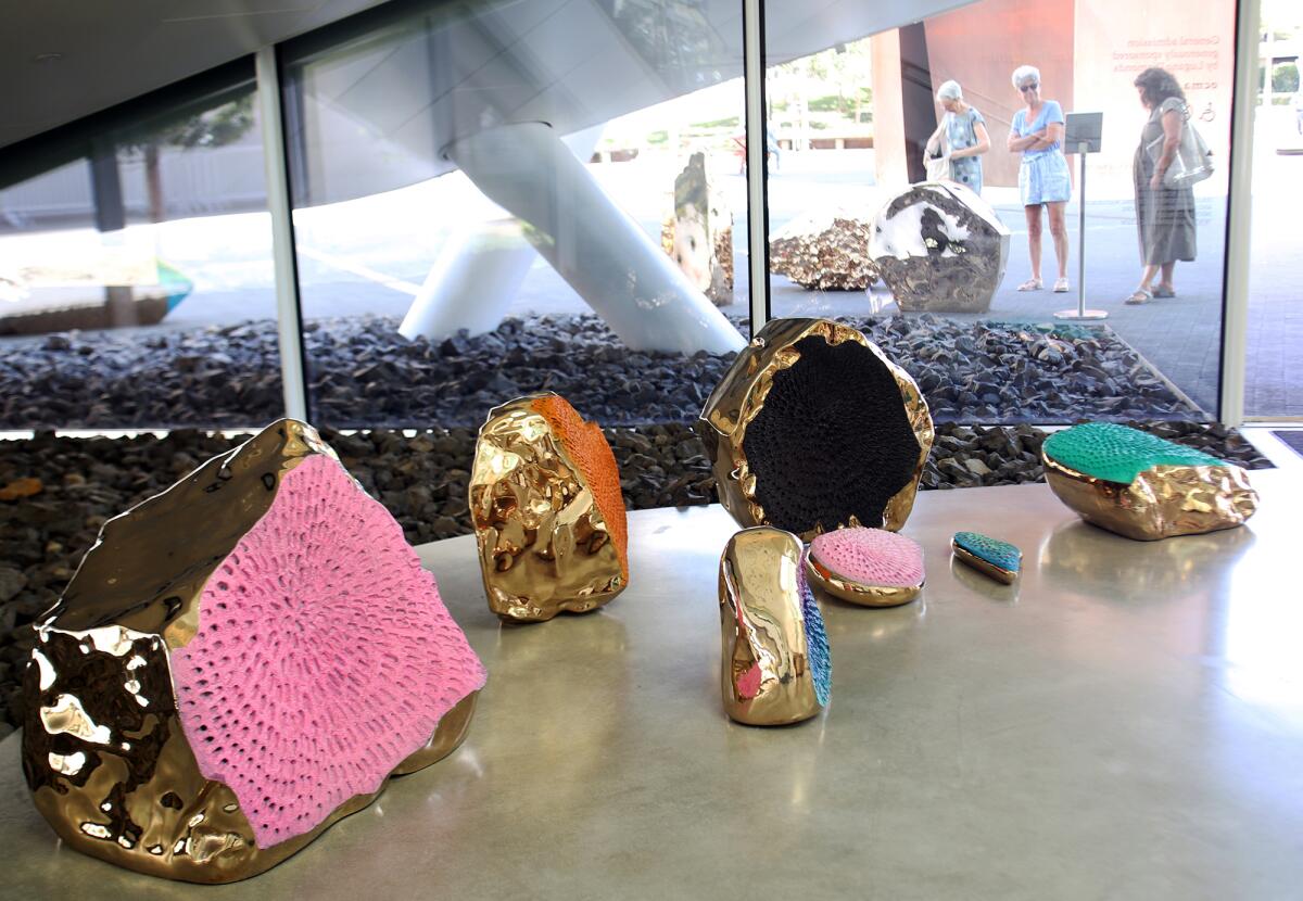 A rock installation painted colors, an interior and exterior installation by Jennifer Guidi. 