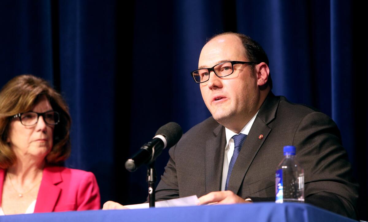 Candidate Terry Walker listens to candidate Keith Eich at the La Cañada Flintridge City Council candidates forum, sponsored by the La Cañada Flintridge Coordinating Council, at Flintridge Prep on Wednesday, Feb. 12.