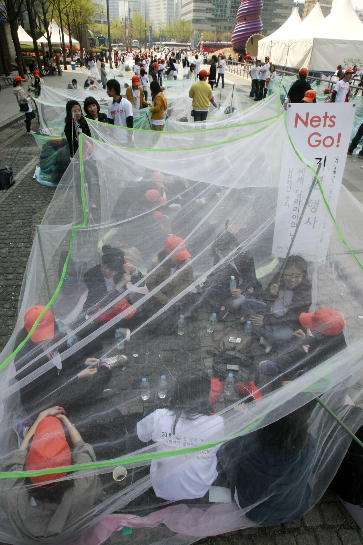 South Korean activists sit in mosquito nets in a campaign to mark World Malaria Day in Seoul in 2010.