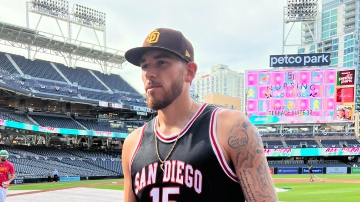 San Diego Padres' Joe Musgrove takes the field in a San Diego State  basketball jersey during warmups before a baseball game against the  Colorado Rockies in San Diego, Friday, March 31, 2023. (