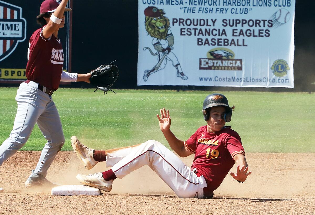 Estancia's Sawyer Atkinson (19) slides safe into second base against Rancho Mirage during Tuesday's game.