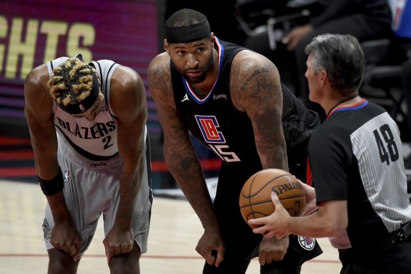 Los Angeles Clippers center DeMarcus Cousins, center, talks with official referee Scott Foster, right, as Portland Trail Blazers forward Rondae Hollis-Jefferson, left, listens during the second half of an NBA basketball game in Portland, Ore., Tuesday, April 20, 2021. The Clippers won 113-112. (AP Photo/Steve Dykes)