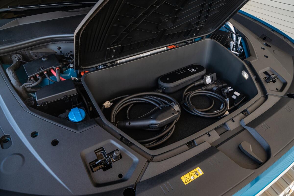 There is a storage "frunk" in the motor area for charging cables.