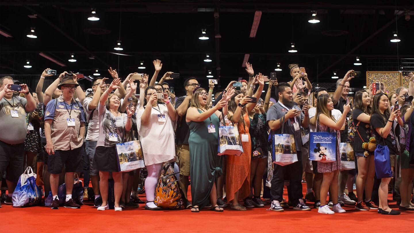 Fans cheer as Disney characters and dancers pass by during the Street Party parade through the exhibit hall. The party kicked off Day One of the D23 Expo, a three-day Disney fan event, on July 14 in Anaheim.