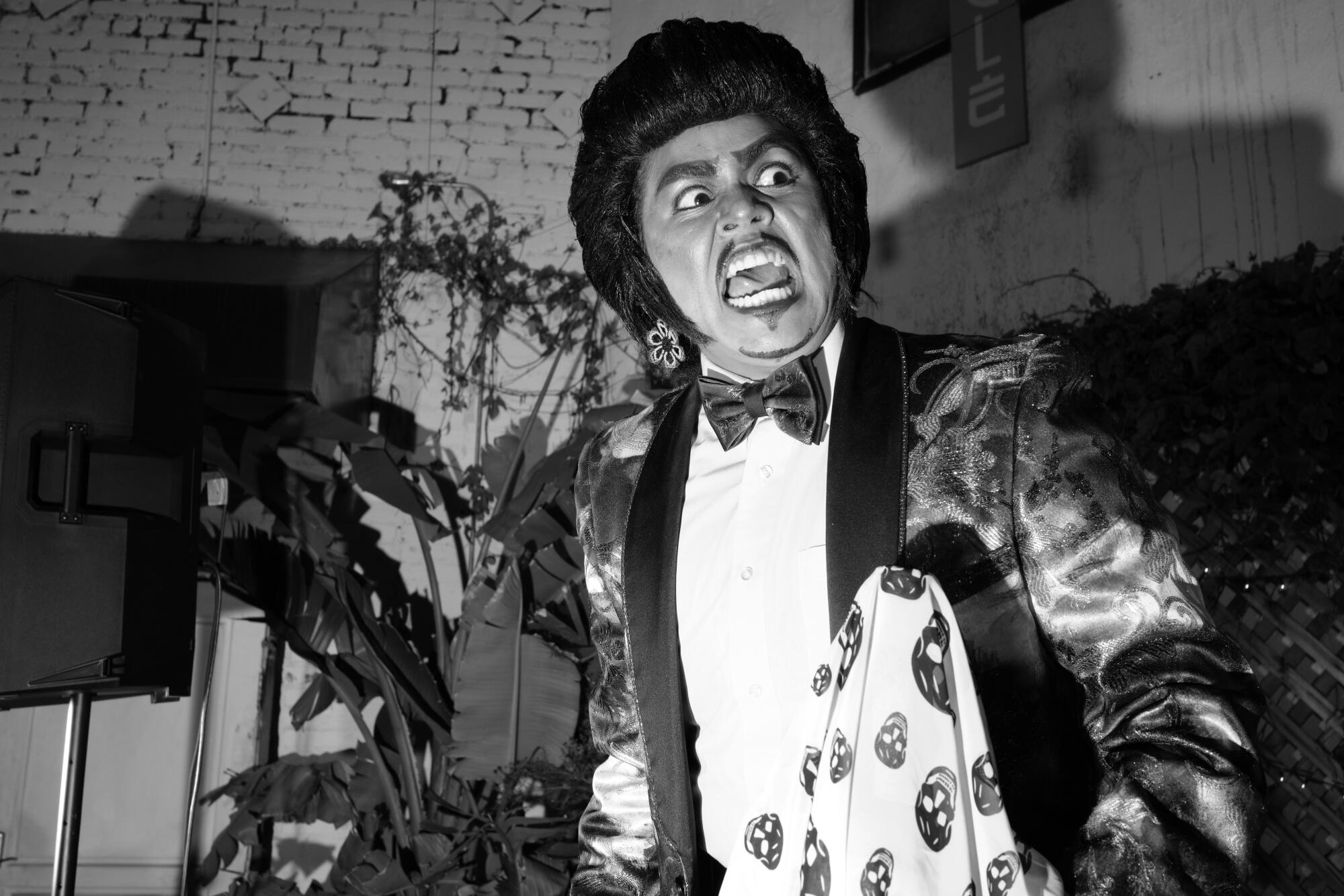 A black-and-white photo of a person in a tux who appears to be angry and screaming.