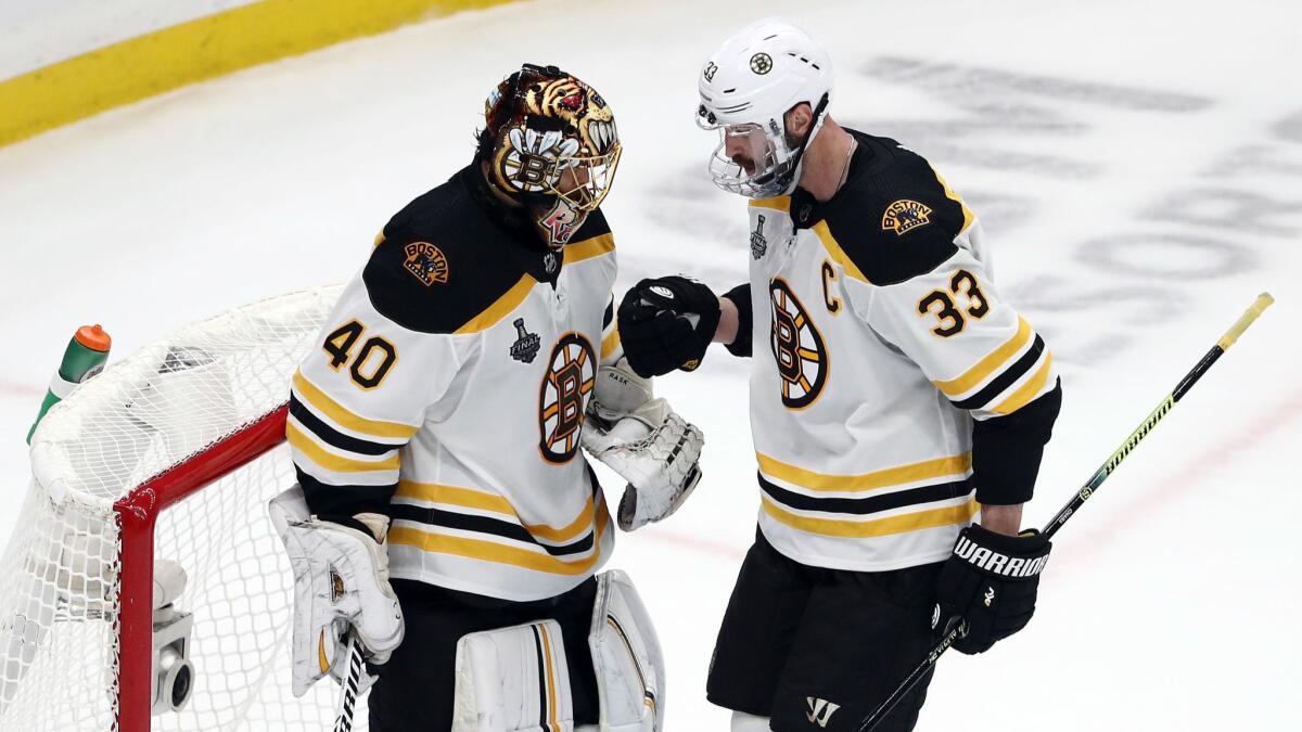 Boston Bruins goaltender Tuukka Rask congratulates defenseman Zdeno Chara on his empty-net goal during Game 6 of the Stanley Cup Final on June 9.