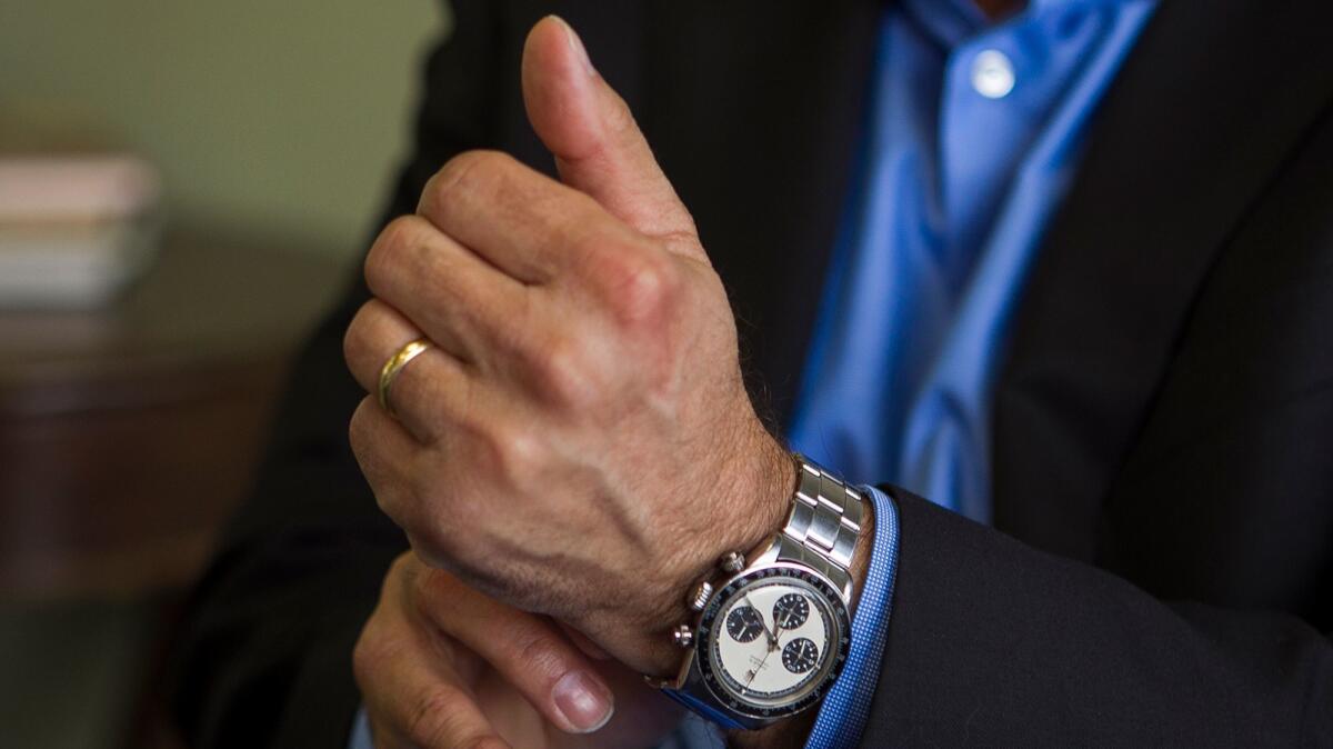 Paul Altieri, the founder and CEO of Huntington Beach-based Bob's Watches, puts on a Paul Newman Rolex Daytona that he has in his personal collection.