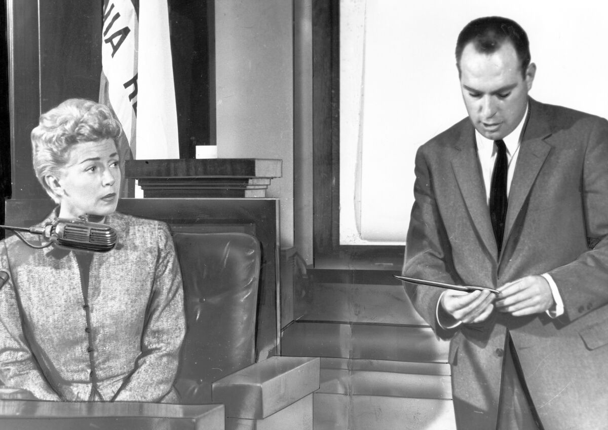 Deputy Dist. Atty. William McGinley, holding the knife used to kill Johnny Stompanato, questions Lana Turner during the April 11, 1958, inquest into the slaying.