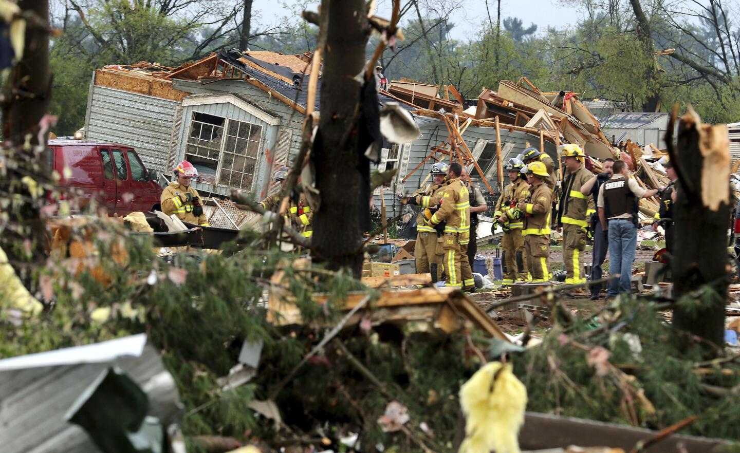 Firefighters work the site of the damage after a tornado ripped through Prairie Lake Estates trailer home park, just north of Chetek, Wis., Tuesday, May 16, 2017. The tornado swept into the mobile home park in western Wisconsin on Tuesday, as a storm system also pounded parts of at least seven states from Texas to near the Canadian border with heavy rain, high winds and hail.