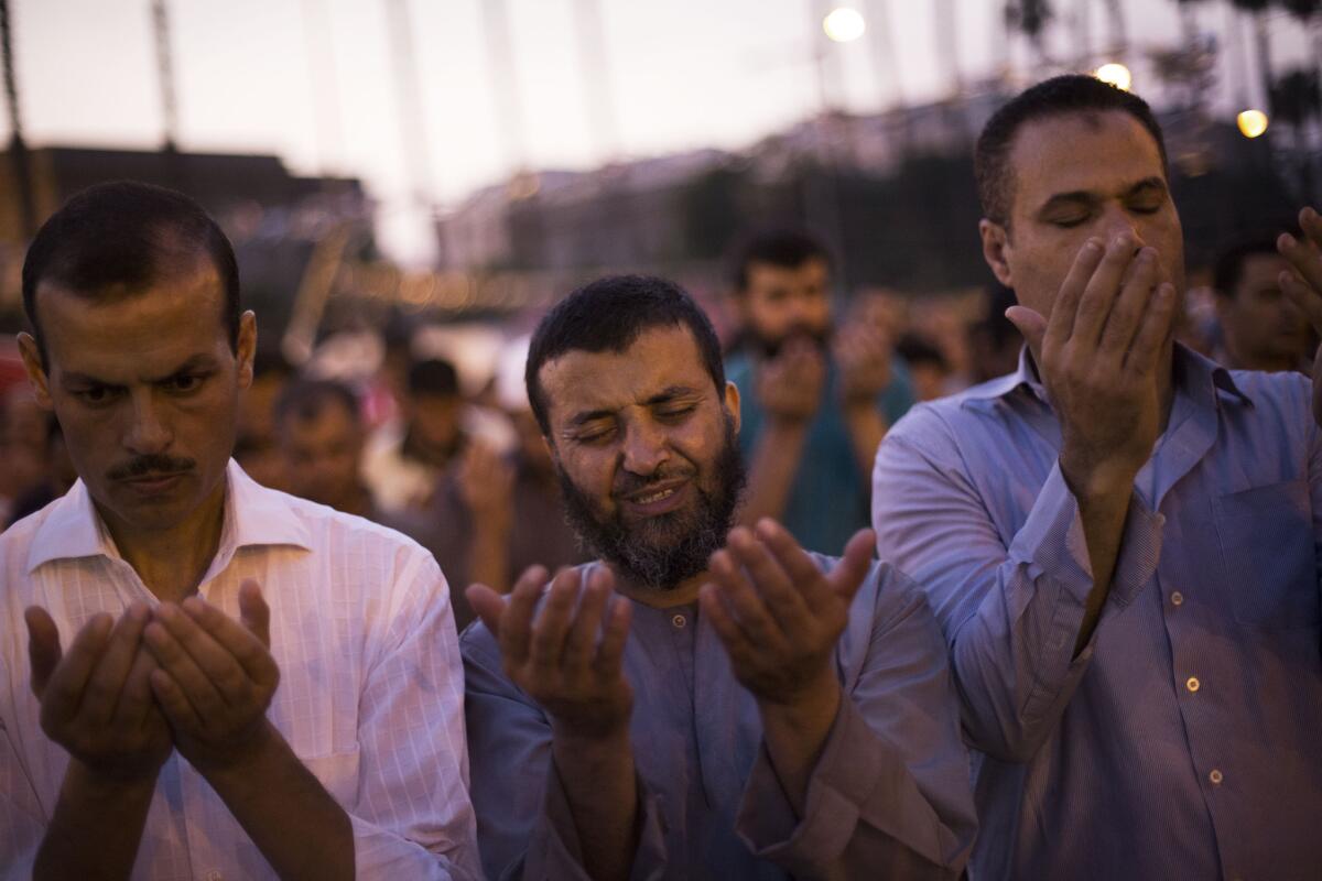 Supporters of Egypt's ousted President Mohamed Morsi pray after the "Iftar" meal during a protest near Cairo University in Giza, Egypt, on Sunday.