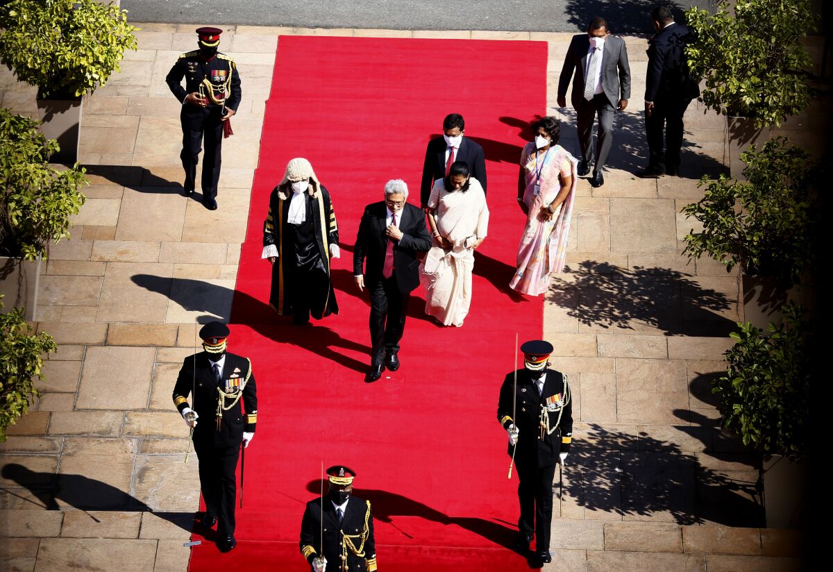 Sri Lankan President Gotabaya Rajapaksa, center, arrives for a new session of Parliament in Colombo, Sri Lanka, Tuesday, Jan. 18, 2022. Rajapaksa on Tuesday promised human rights reforms and “justice” for missing persons from the country's civil war, after years of resisting calls for such measures. (AP Photo)