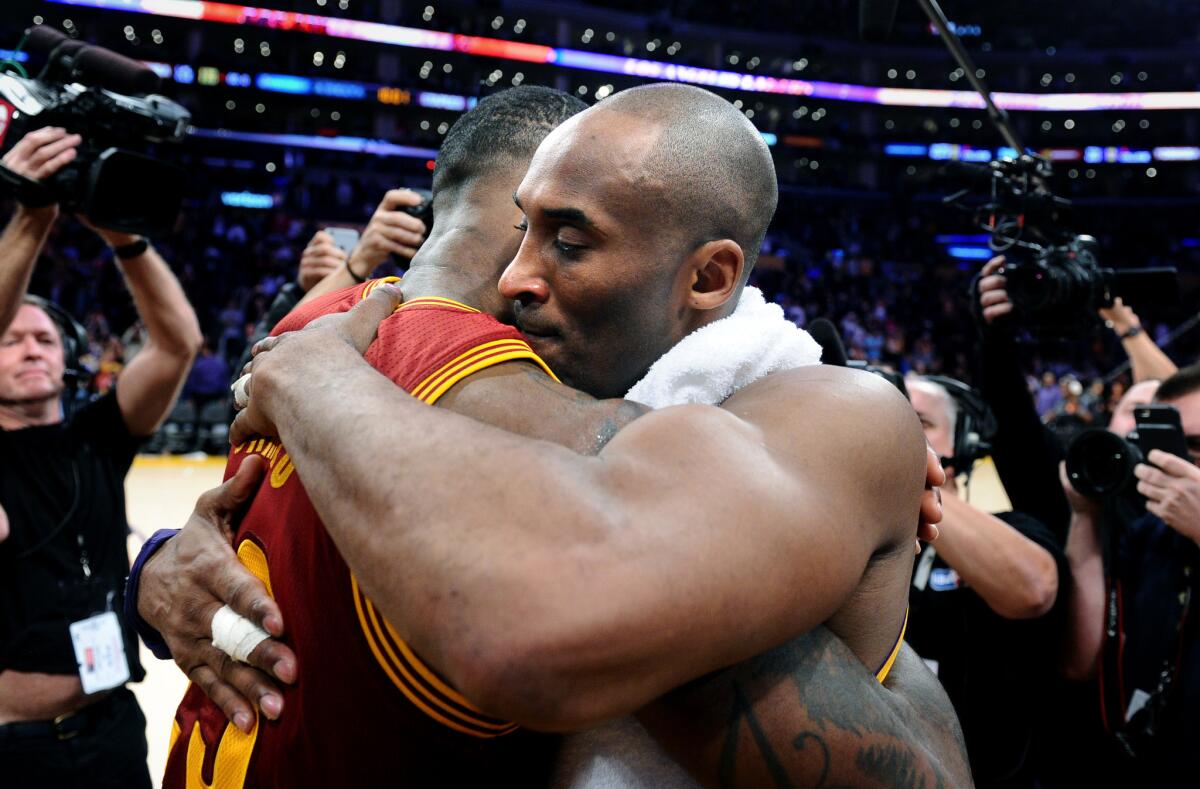 LeBron James and Kobe Bryant hug after the Cavaliers defeated the Lakers, 120-108, on Thursday night at Staples Center.