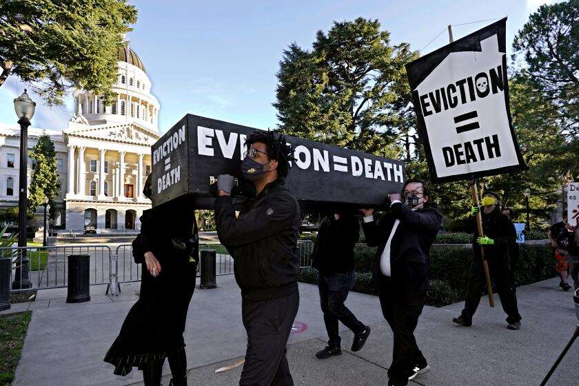 FILE — In this Jan. 25, 2021, file photo, demonstrators call passage of rent forgiveness and stronger eviction protections legislation and carry a mock casket past the Capitol in Sacramento, Calif. California Gov. Gavin Newsom and state legislative leaders are negotiating about whether to extend the state's ban on evictions for unpaid rent. California's eviction protections will expire on June 30. Newsom has proposed using federal coronavirus aid money to pay off 100% of the rent people owe. (AP Photo/Rich Pedroncelli, File)