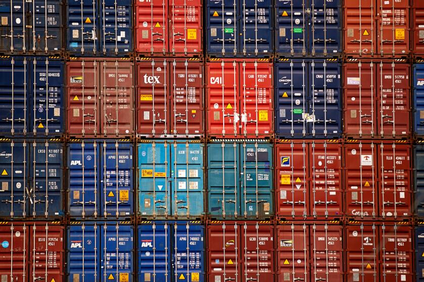 SAN PEDRO, CA - OCTOBER 13: Huge stacks of cargo containers sit at The Port of Los Angeles as growing number of incoming cargo ships wait offshore to unload as the port is set to begin operating around the clock on Wednesday, Oct. 13, 2021 in San Pedro, CA. (Jason Armond / Los Angeles Times)